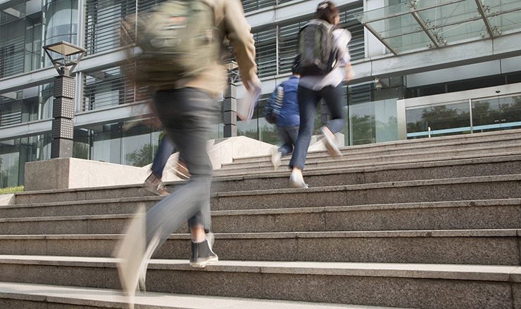 Transnational Education and Globalization: A Look into the Complex Environment of International Branch Campuses lead image: students running up the steps to a building