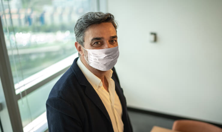 Canada’s Appeal to Prospective Immigrants in the Face of COVID-19 Lead image: Business professional in a mask