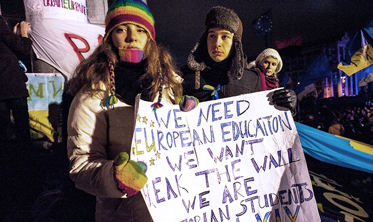 A photograph of Ukrainian student protesters holding a banner that reads, in part, "we need European education."