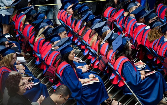 A photo of university students seating at a graduation ceremony.